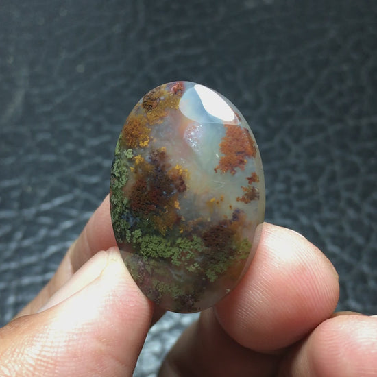 Natural Java Moss Agate cabochon measuring 28.1 x 19.8 x 5.9 mm, cut and polished to an oval shape. Featuring stunning green and brown hues, with touches of yellow within clear chalcedony. Unique underwater-inspired patterns make this piece one-of-a-kind