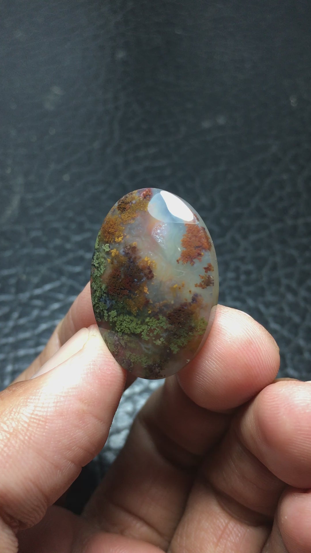 Natural Java Moss Agate cabochon measuring 28.1 x 19.8 x 5.9 mm, cut and polished to an oval shape. Featuring stunning green and brown hues, with touches of yellow within clear chalcedony. Unique underwater-inspired patterns make this piece one-of-a-kind