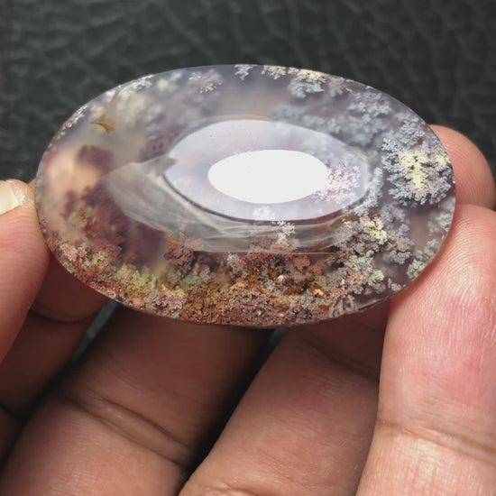 Detailed video of an oval-shaped handcrafted cabochon, created by an expert lapidary artist using unique Java Moss Agate found in East Java, Indonesia.